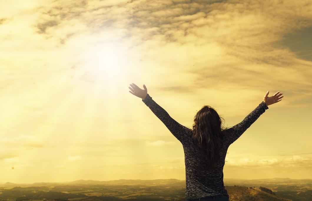 Woman Praying with hands towards the sky